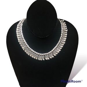 Vintage silver tone choker with articulated tassel-style embellishments.